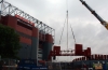 MUFC - Crane lifting out section of bridge.
